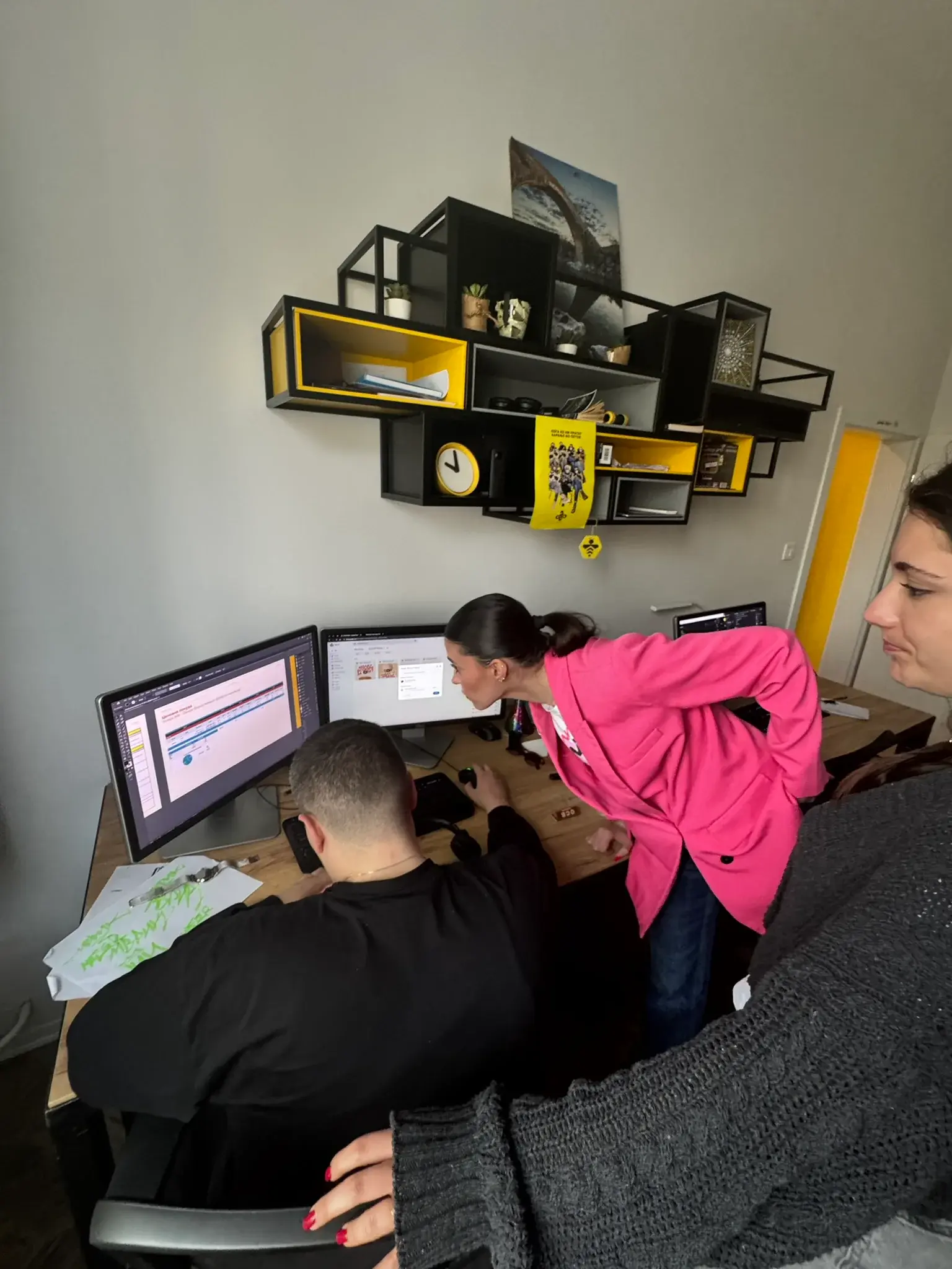 Why Agency collaborators reviewing work at a desk
